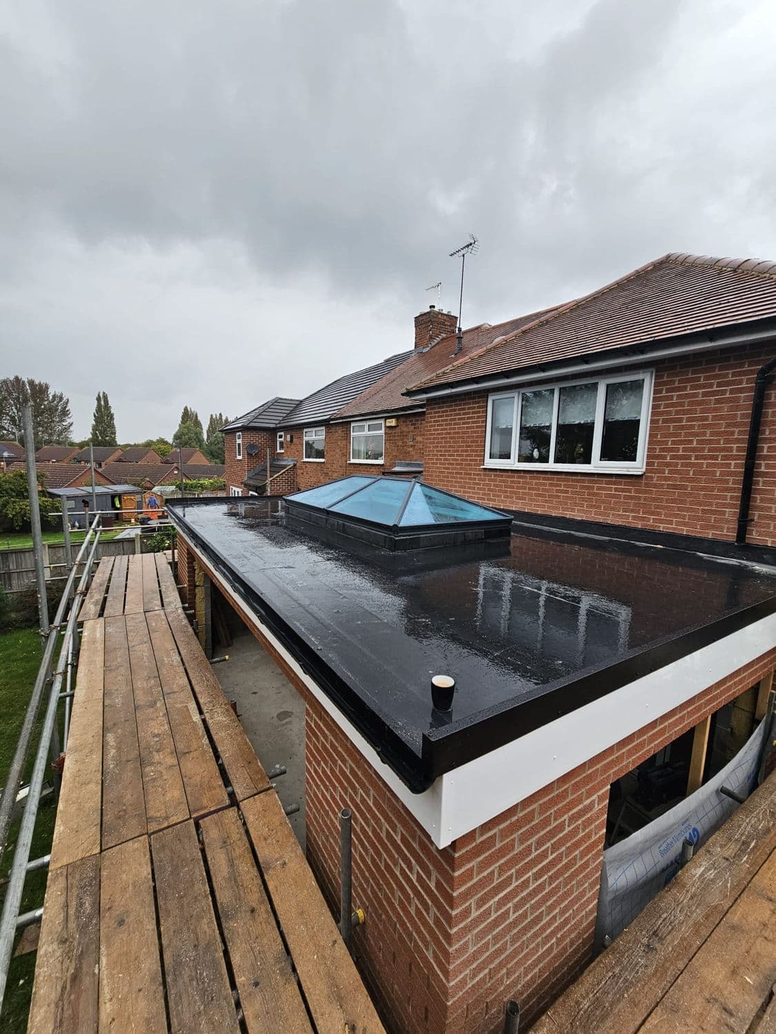 Conservatory with a finished brown tiled warm roof fitted by WeatherTech Roofing
