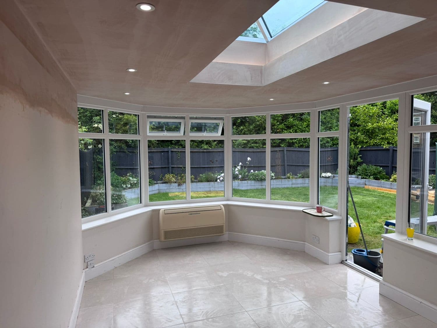 Bright conservatory interior with a vaulted plastered ceiling and rooflight