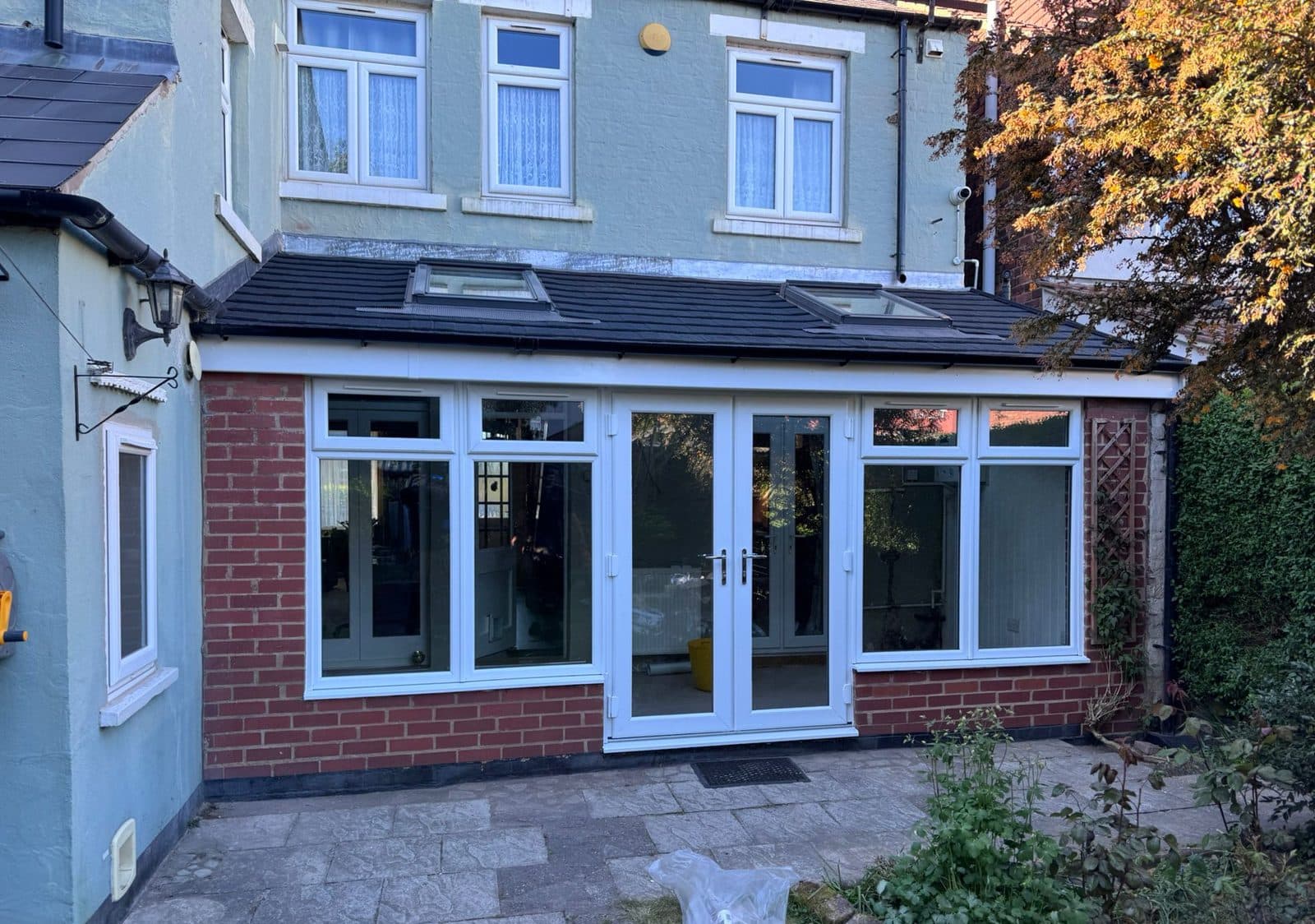 Conservatory with a new tiled warm roof and French doors, finished by WeatherTech Roofing
